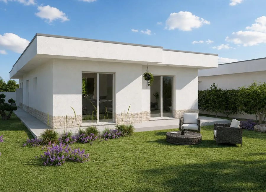 Vista del giardino di giorno con arredo outdoor e grandi vetrate