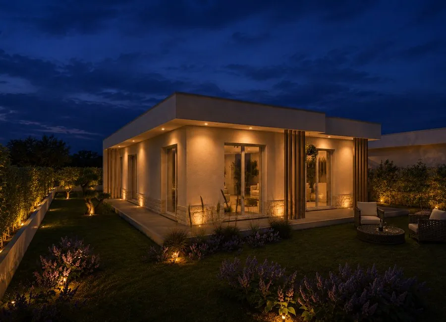 Vista serale d’angolo della villa e del giardino illuminato